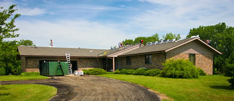 The Roofing Dog crew installing a new asphalt shingle roof on a home in Champaign, Illinois